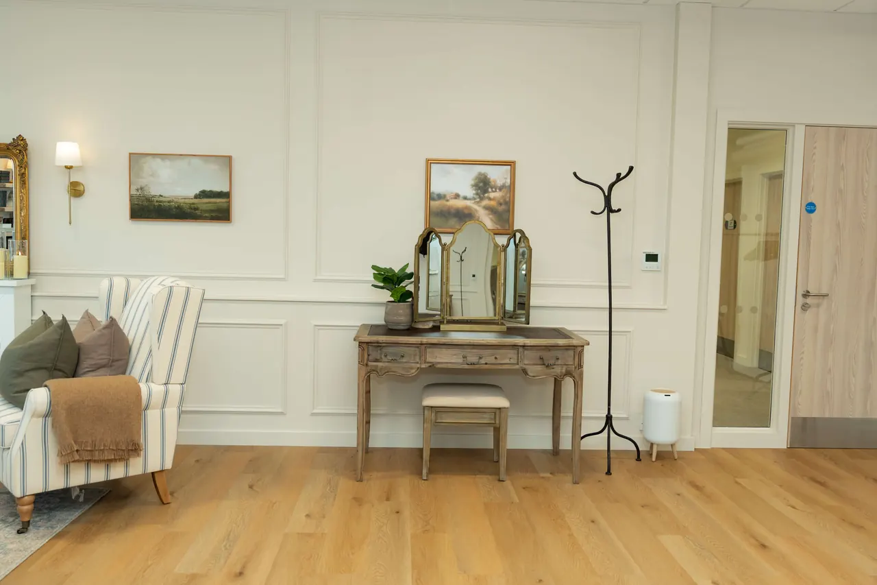 Dressing table with tri-fold mirror and striped wing chair
